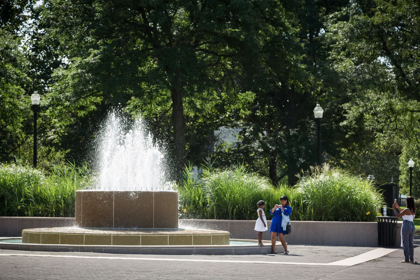 A young girl poses for the camera in front of one of the DIA fountains