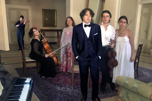 Eric Grossman and family pose in formal wear with their instruments.