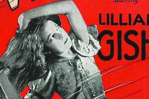 A cropped shot of an old school movie poster, in red, with a figure of a woman holding her arm up to her head in black and white.